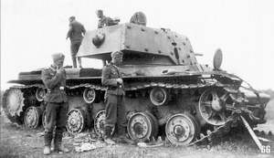 German soldiers examining hit KV-1 tank (with extra armor}. Krasnogvardeisk region, 1941. The tank got under heavy artillery fire - It has many signs of shell hits, the gun was blown from the recoil system