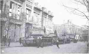 KV-85 tanks and SU-152 self-propelled guns from the 1452nd Self-propelled Artillery Regiment on the streets of liberated town.