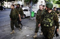 Georgian Defence Minister Davit Kezerashvili (2nd R) walks escorted by his security while walking in the streets of Gori. US Secretary of State Condoleezza Rice today said Russia's military operations in Georgia "really do, now, need to stop" and called on all parties to "cease fire." MARCO LONGARI/AFP/Getty Images.