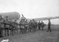 September 17, 1944. Paratroopers of the 82nd Airborne Division assemble next to the transport planes that will be taking them to Holland for Operation Market Garden. National Archives.