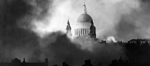 Rising gloriously out of the flames and smoke of surrounding buildings, London's St. Paul's Cathedral is pictured during the great fire raid of December 29, 1940. National Archives.