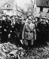 A grim Adolf Hitler, accompanied by other German officials, inspects bomb damage in a German city in 1944. (National Archives)