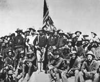 July 1898. Col. Theodore Roosevelt and his Rough Riders pose atop San Juan Heights during the Spanish-American War. (National Archives)