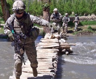 U.S. Army Soldiers navigate across a creek during a dismounted patrol in the Nerkh Valley, June 4, 2009. Photo by Army Staff Sgt. Richard Roman.