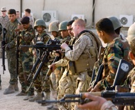 Marine Cpl. William James, assigned to a military training team, shows Iraqi soldiers how to charge an M-16 rifle Dec. 26, 2008, in Basra, Iraq. (U.S. Army photo by Sgt. Gustavo Olgiati)