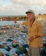 Leon Cooper points to the piles of garbage littering Red Beach on Tarawa.