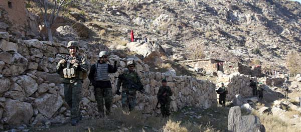 December 17, 2009. Marine 1st Lt. Matthew Orr, assigned to Embedded Training Team 7-5, and Afghan national army soldiers conduct a patrol through Kolak village in Kunar province, Afghanistan. (Sgt. 1st Class Leonardo Torres)