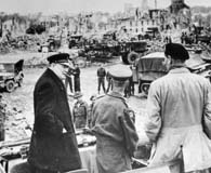 Churchill (left) inspects the ruined city of Caen shortly after it was captured by British forces in July 1944.