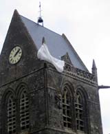 Church of St. Mere Eglise Normandy, where a parachute and effigy of paratrooper John Steele hangs from the steeple.