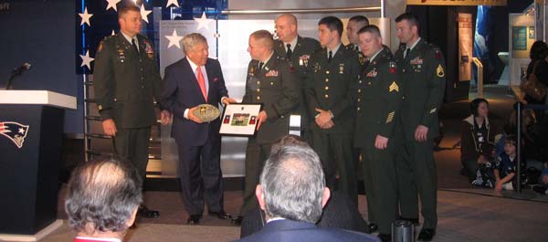 New England Patriots Owner Robert Kraft proudly accepts an item for display in the “Pro Football and the American Spirit” exhibit from members of the Army’s 310th Infantry Regiment, 174th Infantry Brigade, during Saturday’s ceremony. (Photo by John Ingoldsby)
