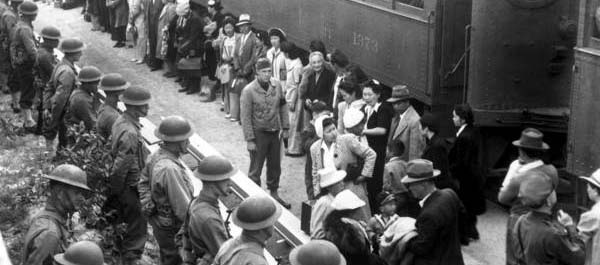 April 5, 1942. Persons of Japanese ancestry arrive at the Santa  Anita Assembly Center from San Pedro, Calif. Evacuees lived at this center at the former Santa Anita race track before being moved inland to relocation centers. (National Archives)