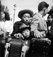 May 2, 1942. These young evacuees of Japanese ancestry are awaiting their turn for baggage inspection upon arrival at this Assembly Center in   Turlock, Calif.  (National Archvies)