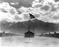 July 3, 1942. A dust storm kicks up at this War Relocation Authority center in Manzanar, Calif., where evacuees of Japanese ancestry are spending the duration of the war. (National Archives)