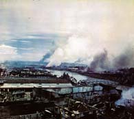 Fires from American artillery and Japanese demolition spread throughout the business district of Manila as U.S. troops continue their advance into the city. (National Archives)