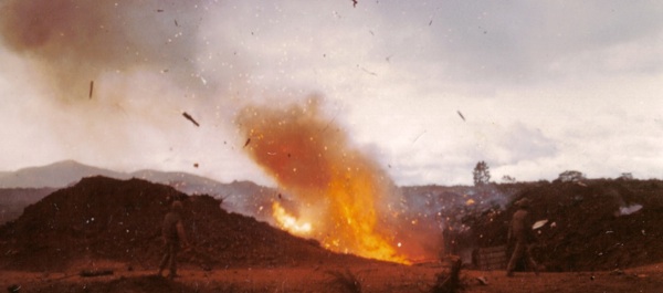 February 23, 1968, the 26th Marine Regiment ammo dump blows after an NVA rocket attack at Khe Sanh. National Archives.