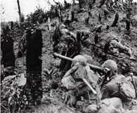 Two Marines armed with a Bazooka inch their way up a hill 2 miles north of Naha during the Battle of Okinawa. (National Archives)