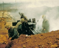 February 14, 1968, a Marine artillery crew fires from Khe Sanh. National Archives.