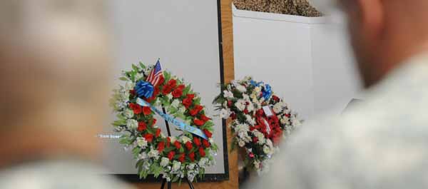 November 11, 2011. Service Members take a moment of silence after the hanging of two wreaths during the Veteran's Day ceremony at Bagram Airfield, Afghanistan. (Army Staff Sgt. Susan Wilt)
