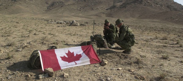 Two Canadian Forces Army Soldiers assigned to 3rd Battalion Princess Patricia’s Canadian Light Infantry (3PPCLI), use a Canadian Flag to mark the Landing Zone (LZ) for a helicopter extraction, in the hills near Qualat, Afghanistan, while participating in Operation Cherokee Sky, an operation to locate and destroy remaining pockets of Al Qaeda and Taliban forces, during Operation ENDURING FREEDOM. (Staff Sgt. Robert Hyatt)