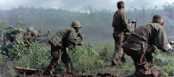Dak To, Vietnam. An Infantry patrol moves up to assault the last Viet Cong position after an attempted overrun of the artillery position by the Viet Cong during “Operation Hawthorne.” June 7, 1966. National Archives.