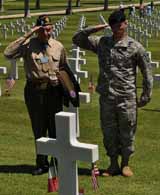 Smith and Staff Sgt. Matthew Labo from 2nd Battalion, 14th Infantry Regiment, share a salute at the Florence American Cemetery in Northern Italy as they honor a division Soldier buried there. Smith and Labo paid their respect to several grave markers at the cemetery during their visit. Labo, who was on a division staff ride served as an honor guard member at ceremony honoring Smith, and a group of other WWII 10th Mountain Division veterans, who were in Italy on a reunion tour. (Sgt. 1st Class John Queen)