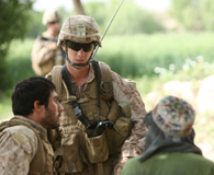 April 23, 2012. A Marine of 2nd Battalion, 5th Marine Regiment, talks to locals in Musa Qa’leh District, Afghanistan during a recent patrol. (Marine Cpl. Kenneth Jasik)
