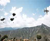 An MC-130 drops supplies for the soldiers of Task Force Cacti (2d Battalion, 35th Infantry Regiment) during Operation Diamond Head in the Chapah Darah District of Kunar province on July 29, 2011. Coalition and Afghan positions in this mountainous area are so remote that they must be resupplied by air. (Spc. Tia Sokimson)