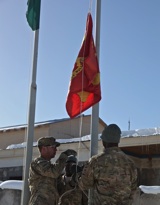 U.S. Army soldiers, 4th Bn, 1st Field Artillery Regiment—Task Force Gunner—raise their command's flag at Forward Operating Base Airborne, Wardak province, Afghanistan, Feb. 15, 2012, during a transfer of authority ceremony. Photo by Spc. Austin Berner 