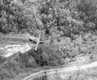 A Ranch Hand UC-123 spraying along a road in central Vietnam, 1966. U.S. Air Force photo.