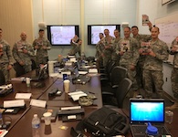 Students in the U.S. Army's Captains Career Course hold the issues of 'Armchair General' they used as a resource. CPT Forrest E. Neumann, author of this article, is third from right.
