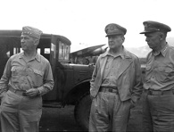 Lt. Gen. Walter Krueger meets with Gen. Douglas MacArthur and Gen. George Marshall at a field HQ in 1943. National Archives.