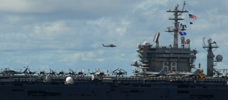 HH-60H Seahawk helicopter above Nimitz-class carrier