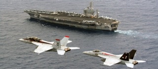 Two F/A-18F Super Hornets over USS Nimitz