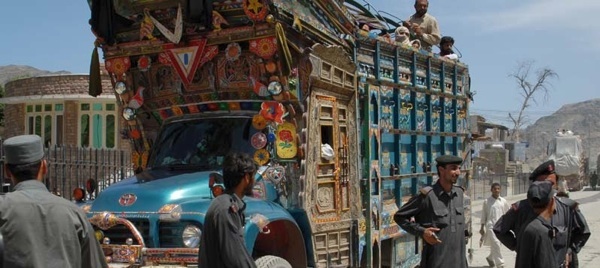 A jingle truck packed with people and farm animals crosses into Afghanistan at the Torkham Gate crossing. Thousands of people use this border crossing between Pakistan and Afghanistan each day. Photo by Petty Officer 1st Class Scott Cohen.