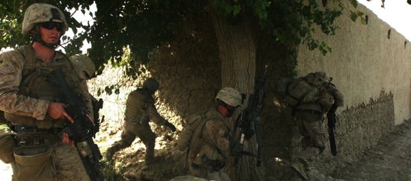 Marines from Company F, 2nd Battalion, 8th Marine Regiment, take cover after receiving enemy fire during a patrol near Lakari Village, July 19, 2009. Photo by Marine Sgt. Scott Whittington.