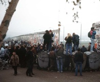 A crowd of West German citizens gathers at the newly created opening in the Berlin Wall at Potsdamer Platz in 1989.