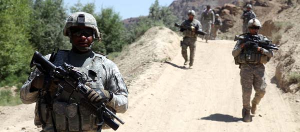 June 30, 2010. U.S. Soldiers assigned to the 401st Military Police Company, 720th MP Battalion, 89th MP Brigade patrol the village of Shaghasi Kala in Logar Province, Afghanistan. (Department of Defense)