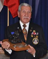 Penobscot Elder Charles Shay receives a plaque commemorating his service from the 264th Medical Battalion. (L.A. Shively)
