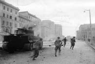 June 2, 1944. Soldiers of the 88th Infantry Division sprint past a Tiger tank knocked out on the outskirts of Rome. (National Archives)