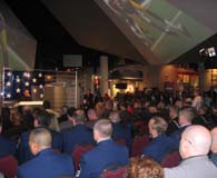 Bob Filosa, (at podium) Raytheon&rsquo;s Director of Program Management, speaks to the standing-room-only crowd during ceremonies on Saturday at The Hall at Patriot Place presented by Raytheon. (Photo by John Ingoldsby)