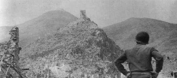 The ruins of Cassino, 1944. The Abbey of Monte Cassino is just visible at the top of the mountain on the left side of the photo. (National Archives)