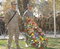 November 11, 2011. Marine Sgt. Greggory Evander and Air Force Tech. Sgt. Richard Shipman stand by the American wreath during a multinational, memorial ceremony honoring the sacrifices of veterans and civilians during times of war. (Air Force Master Sgt. Reginal Woodruff)