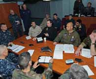 Liaison officers from coalition countries meet with U.S. Joint Task Force Odyssey Dawn staff members aboard the command ship USS Mount Whitney to discuss command and control of the multiphase international military operations in the Mediterranean Sea March 21, 2011. (Petty Officer 2nd Class Daniel Viramontes)