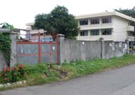 Site ofÂ Victorio's old family home and cornerÂ lot (gated), which stands directly across the belfry side of St. Dominic Cathedral (previous photo). (Joel Nunez)