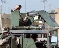 August 12, 2004. Marines of 11th Marine Expeditionary Unit man a position in Najaf, Iraq during a raid of the Muqtada Militia strong points in the area. U.S. Marine Corps photo.