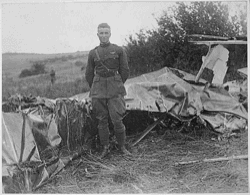 Luke beside the wreckage of a balloon. National Archives.