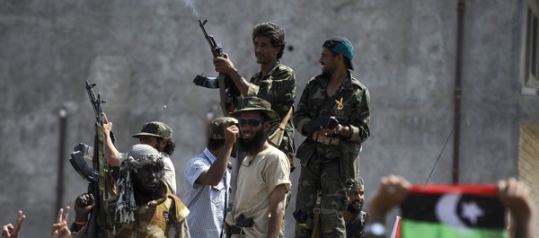 August 27, 2011. Libyan rebels fire into the air as they celebrate following the takeover of a southwestern neighborhood of Tripoli. (Filippo Monteforte/AFP/Getty Images)
