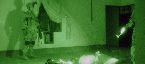 US Army Task Force 1st Battalion, 163rd Mechanized Infantry Headquarters Company, Montana Army National Guard, Helena, Montana, Quick Response Force Soldiers guard detainees. Photo by Spc. Gul A. Alisan.