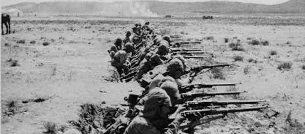 British soldiers attempt to hold back Boer fighters.