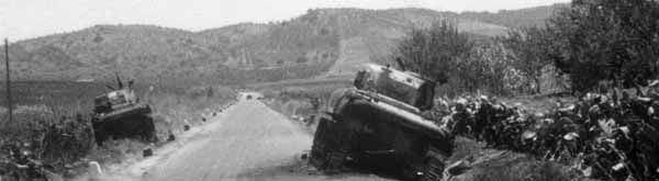July 24, 1943. Members of the 505th Parachute Infantry Regiment come upon several knocked out American tanks as they advance from Gela to Trapani during the Battle of Sicily. (National Archives) 